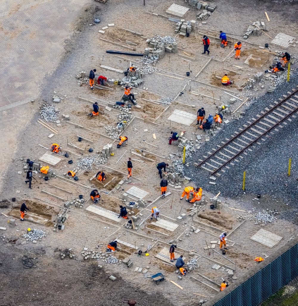 Aerial image Oberhausen - Apprentices in practical vocational training on a construction site for laying paving stones as flooring on a training construction site at the Gartendom in Oberhausen in the Ruhr area in the state North Rhine-Westphalia, Germany