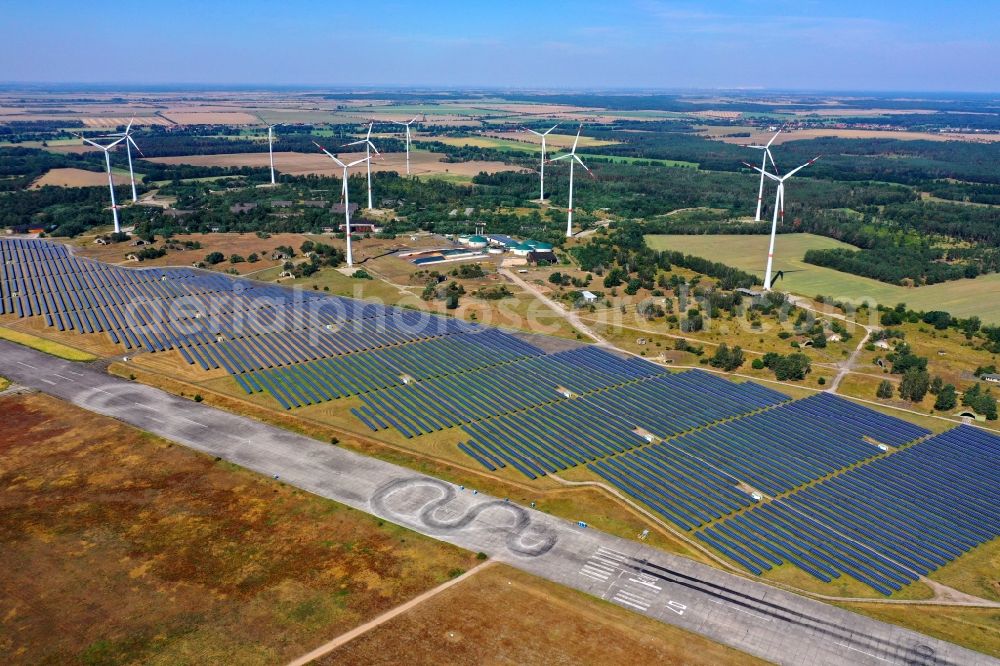 Zerbst/Anhalt from the bird's eye view: Zerbst airfield and solar power plant - photovoltaic park and wind farm on the open spaces of Zerbst airfield in the state of Saxony-Anhalt
