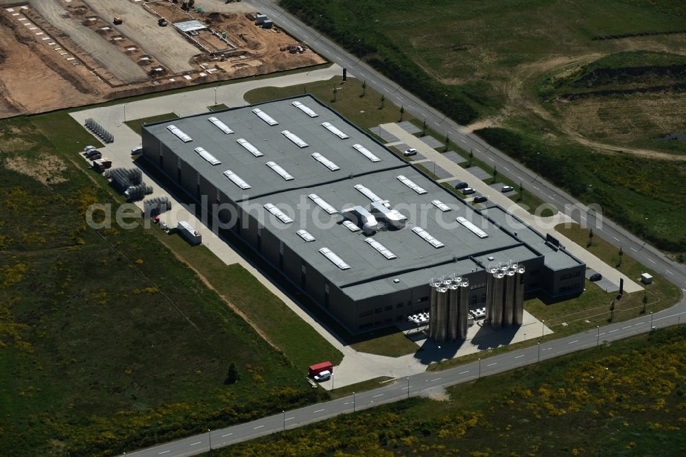 Aerial image Schwerin - Production site of Procap in the Industrial Park Schwerin in Schwerin in the state of Mecklenburg - Western Pomerania. The newly developed industrial and commercial area is currently under construction in a forest area in the South of Schwerin. Some buildings - such as the new works of the plastics manufacturer - are already in use