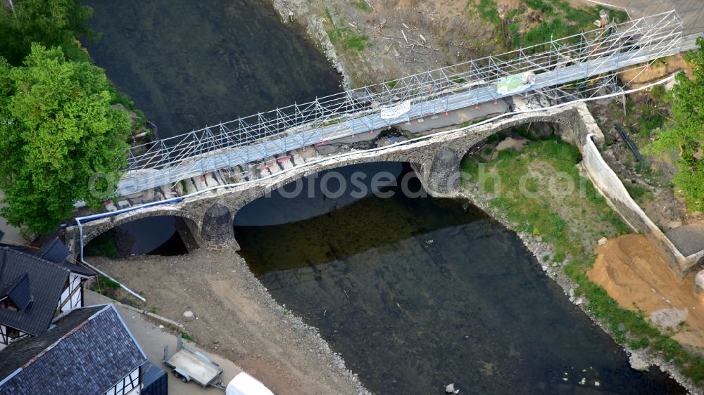 Schuld from the bird's eye view: Flood damage and reconstruction construction sites in the flood area at a bridge that was provisionally prepared for pedestrians over the course of the river Ahr on street Domhofstrasse in Schuld in the state of Rhineland-Palatinate, Germany