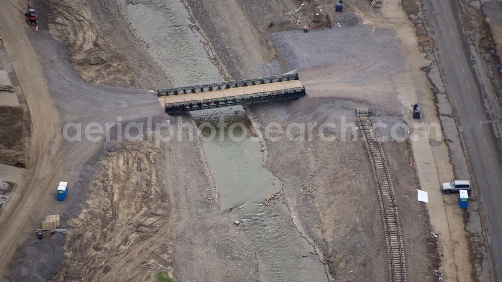 Dernau from the bird's eye view: Temporary bridge over the Ahr in Dernau after the flood disaster in the Ahr valley this year in the state Rhineland-Palatinate, Germany. The concrete bridge a few meters above, which collapsed due to the flood, is already removed
