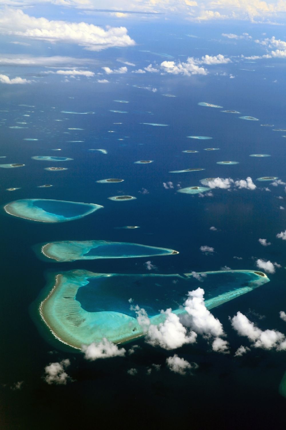 Aerial photograph Dharanboodhoo - Cumulus clouds overcast Coastal Indian Ocean - island in Dhahran Boodhoo in Central Province, Maldives