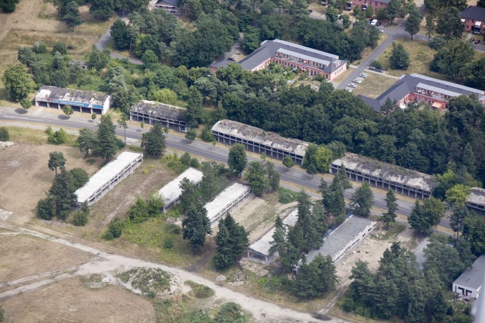 Aerial photograph Wustermark OT Elstal - The peripheral development of the former Olympic Village in Elstal in Brandenburg. The original edge development is largely destroyed. Former garage areas are designed as exclusive residences