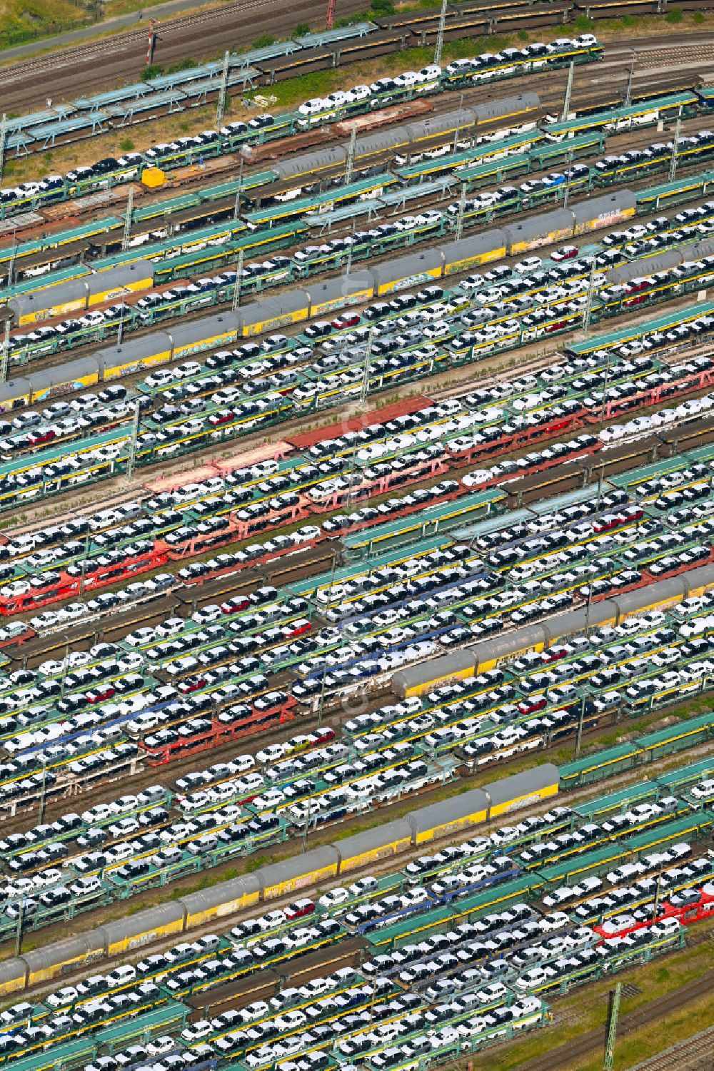 Bremen from the bird's eye view: Marshalling yard and freight station with car and new car transport on street Marienwerderstrasse in Bremen, Germany