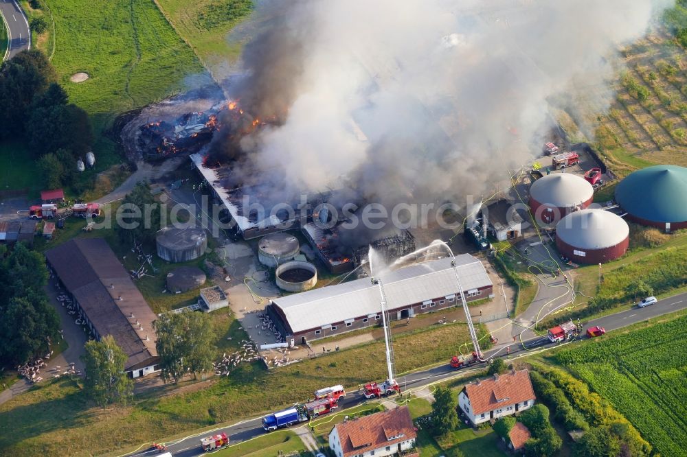 Dassel from the bird's eye view: Smoke and flames during the fire fighting to fire on Experimental property of the University of Goettingen in the district Relliehausen in Dassel in the state Lower Saxony, Germany