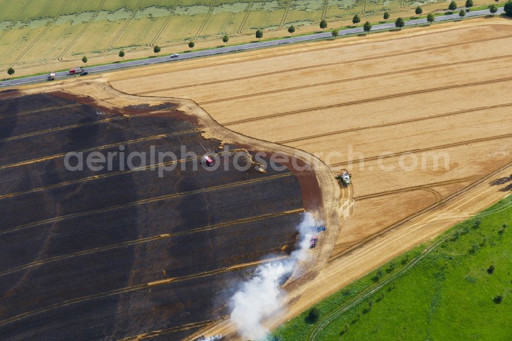 Aerial photograph Leinefelde-Worbis - Smoke and flames during the fire fighting to fire eines Getreidefeldes in Leinefelde-Worbis in the state Thuringia