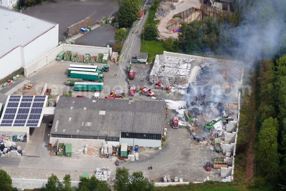Witzenhausen from above - Smoke and flames during the fire fighting to fire of company Heil Recycling in Witzenhausen in the state Hesse, Germany