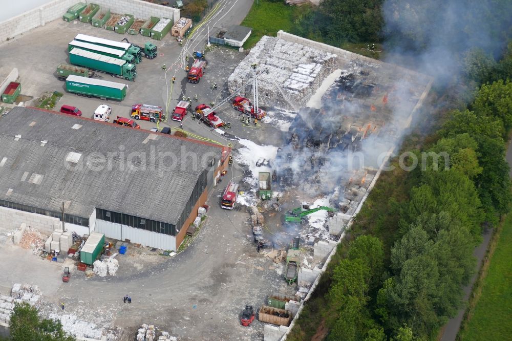 Witzenhausen from the bird's eye view: Smoke and flames during the fire fighting to fire of company Heil Recycling in Witzenhausen in the state Hesse, Germany