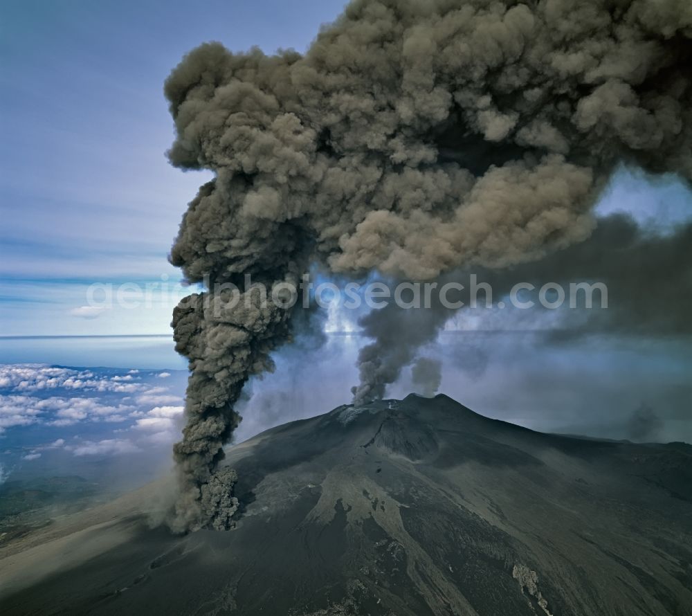 Aerial image Sizilien - Black plumes of smoke above the volcano crater with landscape Aetna in Sicilia, Italy