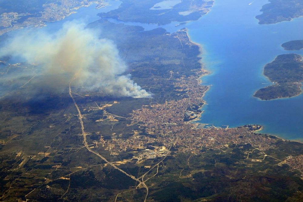 Vodice from above - Smoke clouds by a great fire in the forest next to Vodice at the Mediterranean Sea in Sibensko-kninska zupanija, Croatia