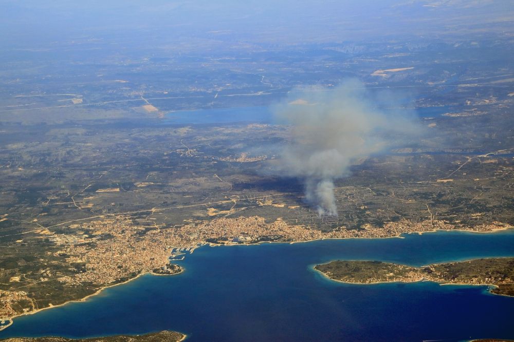 Aerial image Vodice - Smoke clouds by a great fire in the forest next to Vodice at the Mediterranean Sea in Sibensko-kninska zupanija, Croatia