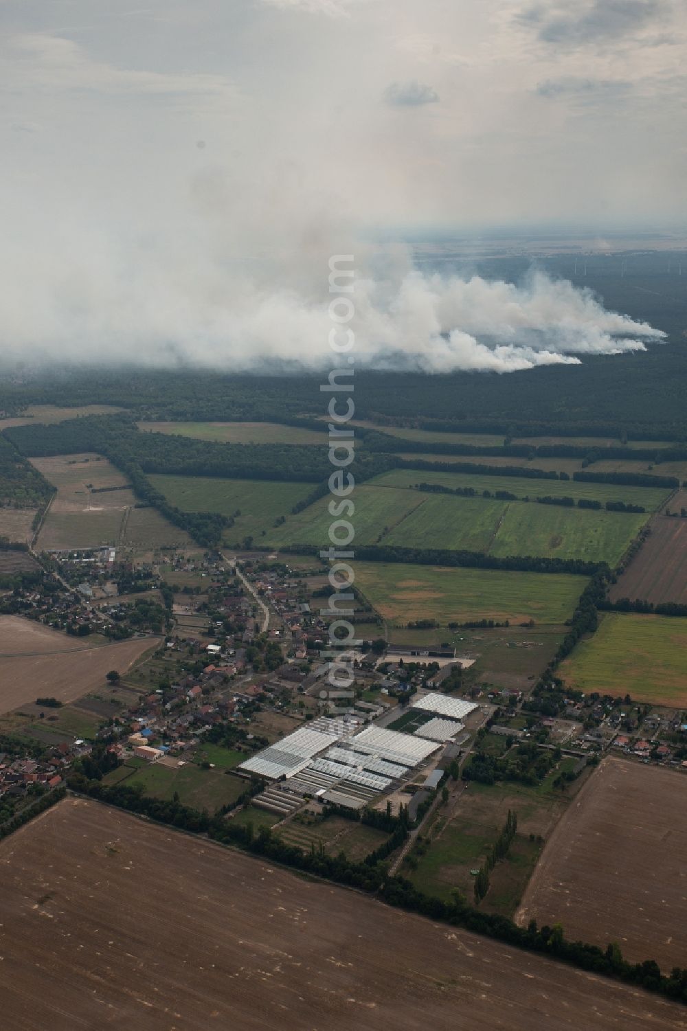 Kemnitz from the bird's eye view: Smoke clouds by the Great Fire - destroyed forest fire tree population in a wooded area - forest terrain in Kemnitz near Treuenbrietzen in the state Brandenburg, Germany