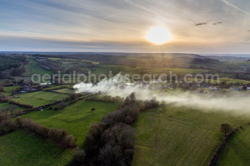 Saisy from the bird's eye view: Smoke clouds of a fire in a cornfield in Saisy in Bourgogne-Franche-Comte, France