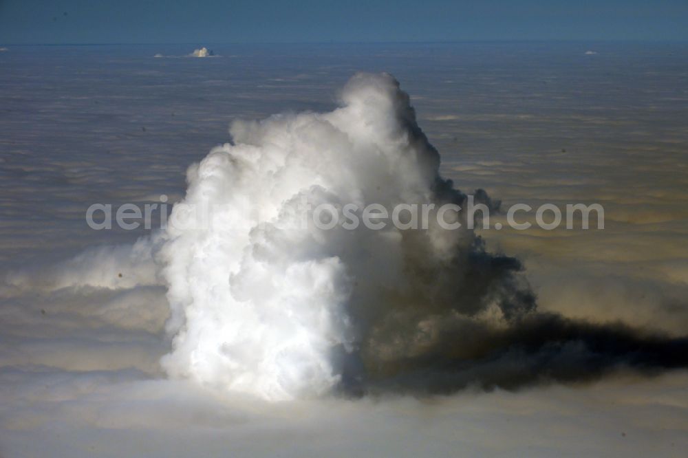 Aerial image Lippendorf - Exhaust gases from the power plant and exhaust gas towers of the thermal power plant of LEAG Lausitz Energie Kraftwerke AG in Lippendorf in the state of Saxony, Germany, break through vertically through a closed layer of high fog