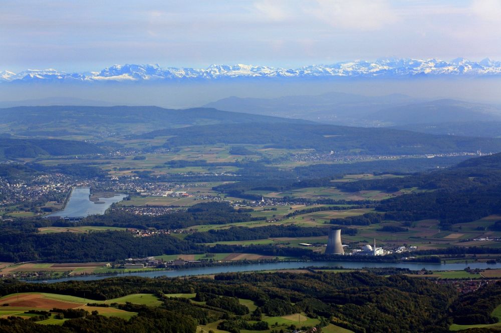 Leibstadt from the bird's eye view: Reactor unit and cooling Tower of the NPP nuclear power plant Leibstadt in Leibstadt in the canton Aargau, Switzerland. Looking from Germany over the river Rhein to the mouth of Aare and the summits of Swiss Alps