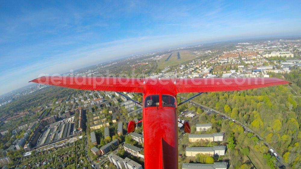 Berlin from the bird's eye view: Airplane - red Cessna F 172H of the agency euroluftbild.de with the identification D-EGYC during a low approach over runway 26R in flight over Tegel Airport in Berlin, Germany