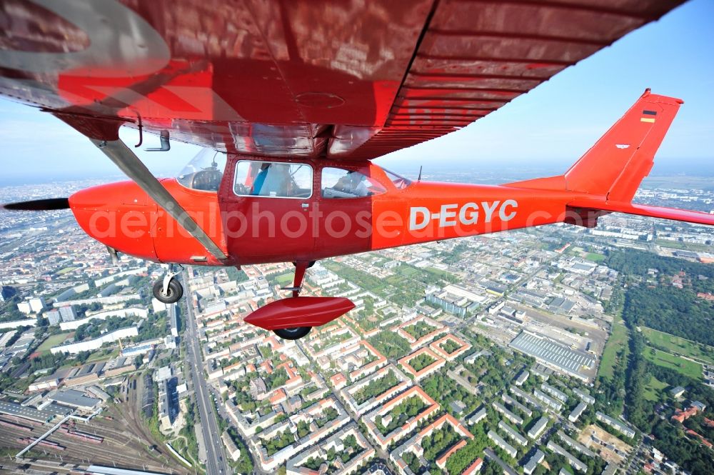Berlin from above - Bright red Cessna 172 D-EGYC of the agency euroluftbild.de in flight over the district Friedrichshain in Berlin, Germany