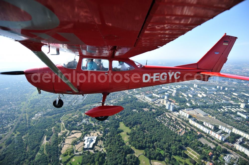 Aerial image Berlin - Bright red Cessna 172 D-EGYC of the agency euroluftbild.de in flight over the district Friedrichshain in Berlin, Germany