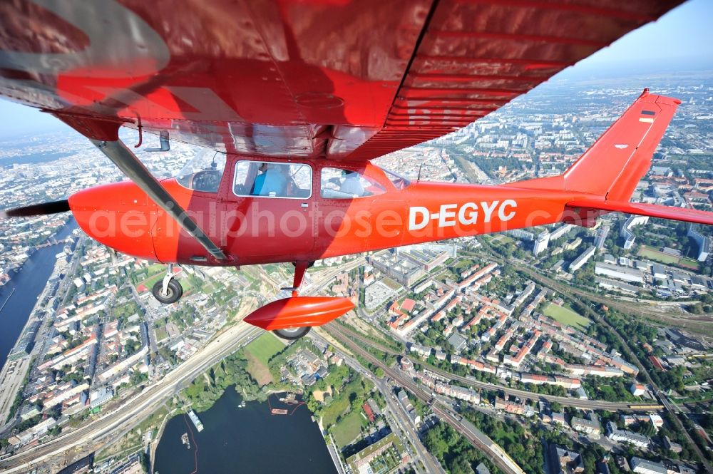 Berlin from above - Bright red Cessna 172 D-EGYC of the agency euroluftbild.de in flight over the district Friedrichshain in Berlin, Germany
