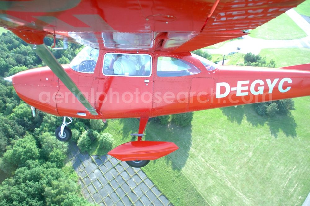 Aerial photograph Werneuchen - Bright red Cessna 172 D-EGYC of the agency euroluftbild.de in flight over the airfield in Werneuchen in the state Brandenburg, Germany