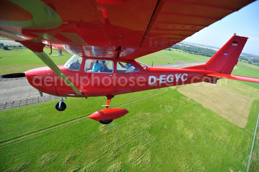 Werneuchen from above - Bright red Cessna 172 D-EGYC of the agency euroluftbild.de in flight over the airfield in Werneuchen in the state Brandenburg, Germany