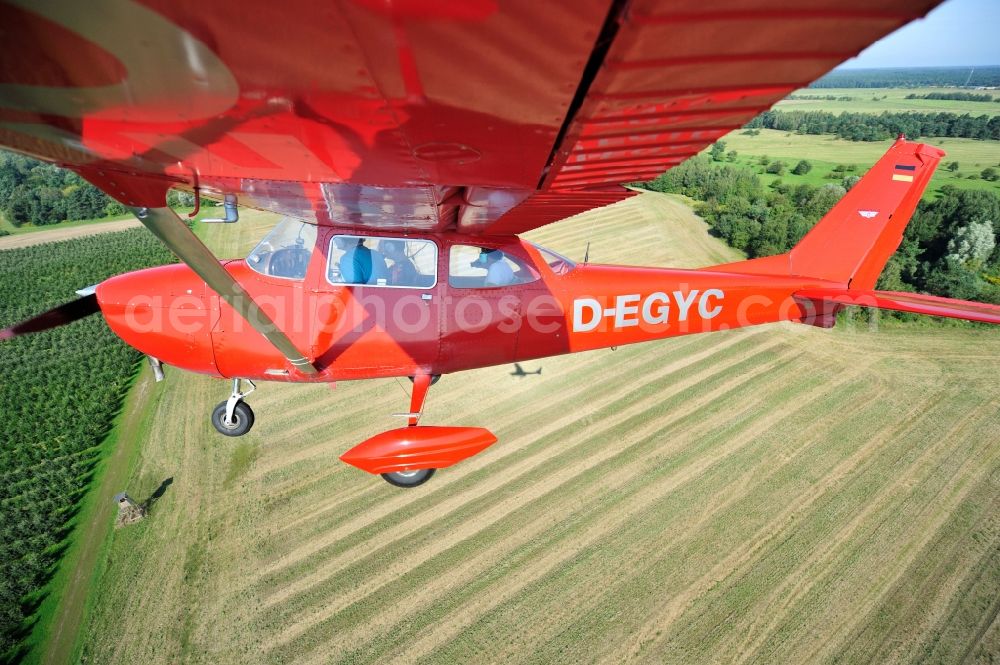 Aerial image Werneuchen - Bright red Cessna 172 D-EGYC of the agency euroluftbild.de in flight over the airfield in Werneuchen in the state Brandenburg, Germany