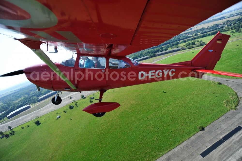 Werneuchen from above - Bright red Cessna 172 D-EGYC of the agency euroluftbild.de in flight over the airfield in Werneuchen in the state Brandenburg, Germany