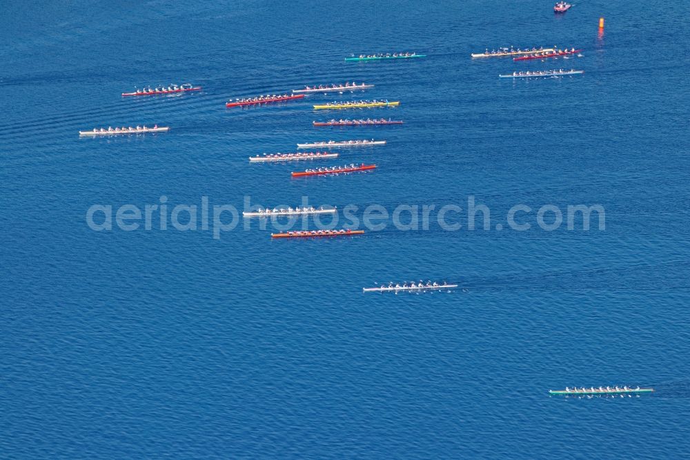 Starnberg from above - Rowing boats at the rowing regatta Roseninsel-8er on the Starnberger See in front of Starnberg in the state of Bavaria. The event is annually organized by the Munich Rowing and Sailing Association
