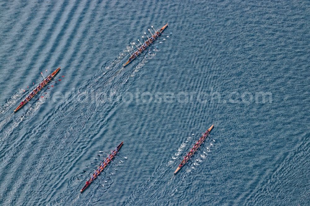 Starnberg from above - Rowing boats at the rowing regatta Roseninsel-8er on the Starnberger See in front of Starnberg in the state of Bavaria. The event is annually organized by the Munich Rowing and Sailing Association