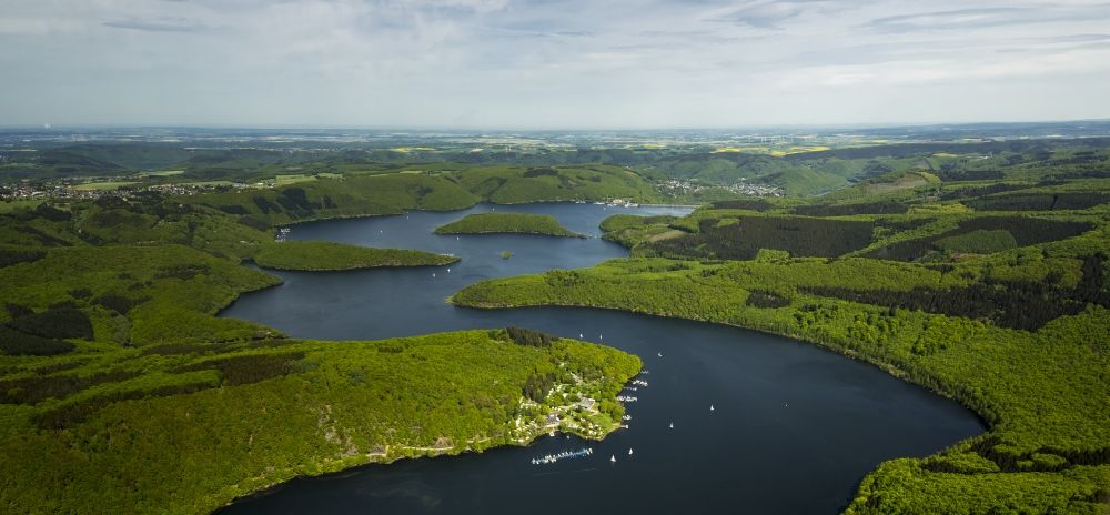 Aerial photograph Simmerath - Rur barrier lake in Simmerath in the state of North Rhine-Westphalia. The barrier lake is the second largest in Germany and surrounded by forest and hills on the lakeside. It is located in the Eifel region. A boat dock and the sports facilities of RWTH University Aachen are located on a small peninsula