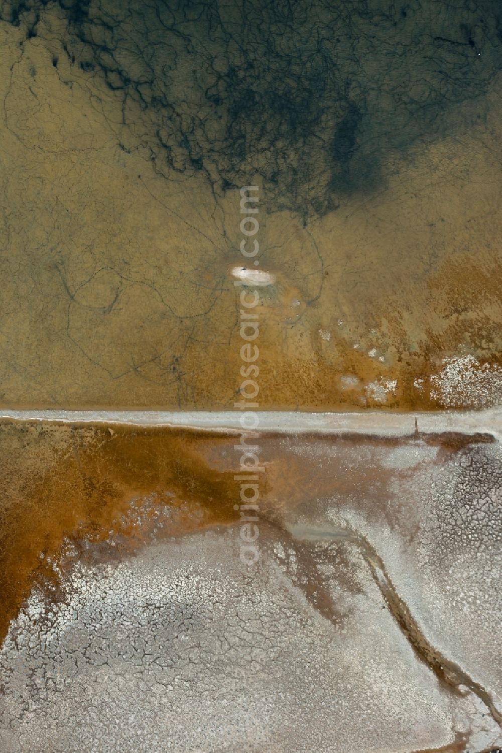 Aerial image Llucmajor - Brown - white salt pans for salt extraction in Llucmajor in Balearic Islands, Spain