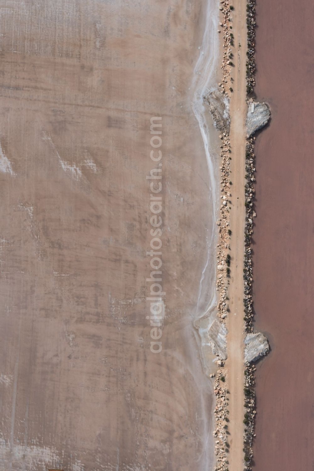 Aerial image Llucmajor - Brown - white salt pans for salt extraction in Llucmajor in Balearic Islands, Spain