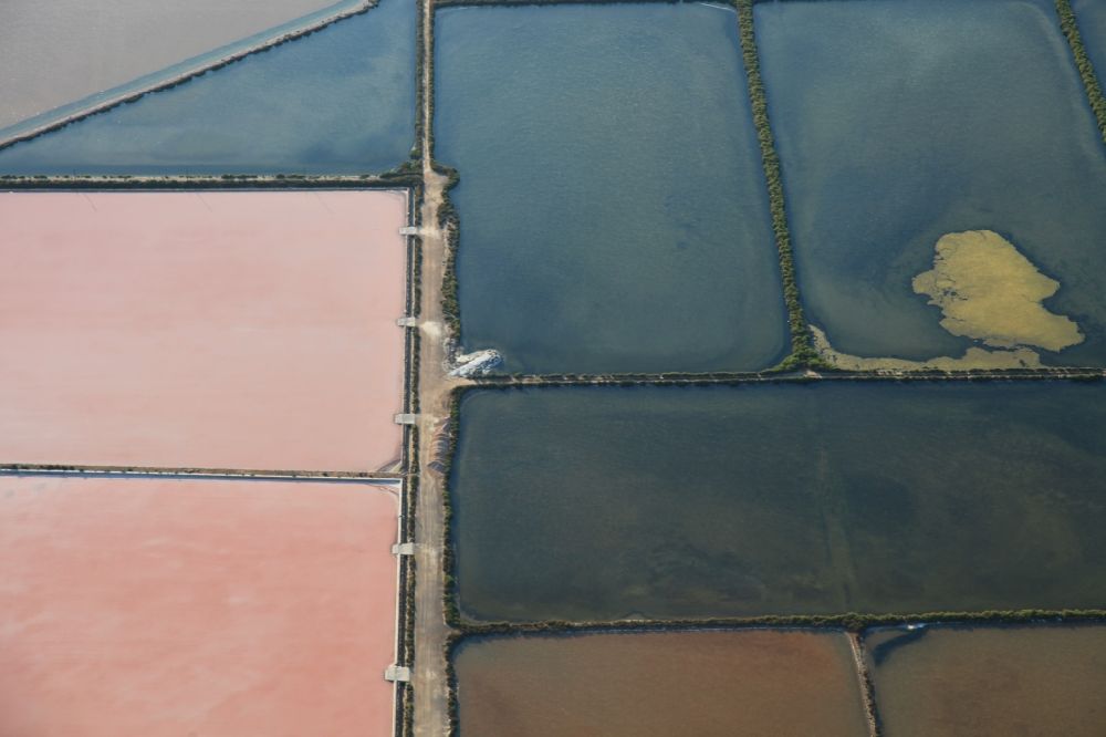 Aerial image Colonia de Sant Jordi - Brown - white pink salt pans for salt extraction Ses salines d'es trenc in Mallorca in Balearic Islands, Spain
