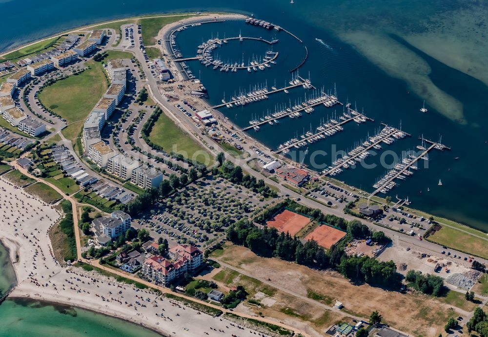 Fehmarn from the bird's eye view: Sandy beach landscape with holiday homes and marina in Burgtiefe on Fehmarn in the state Schleswig-Holstein, Germany
