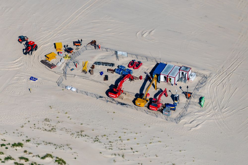 Norderney from above - Sandy beach landscape machine, construction trailer excavator for flushing sand onto the beach on the island of Norderney in the state Lower Saxony, Germanyy