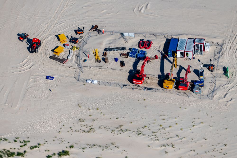 Norderney from the bird's eye view: Sandy beach landscape machine, construction trailer excavator for flushing sand onto the beach on the island of Norderney in the state Lower Saxony, Germanyy