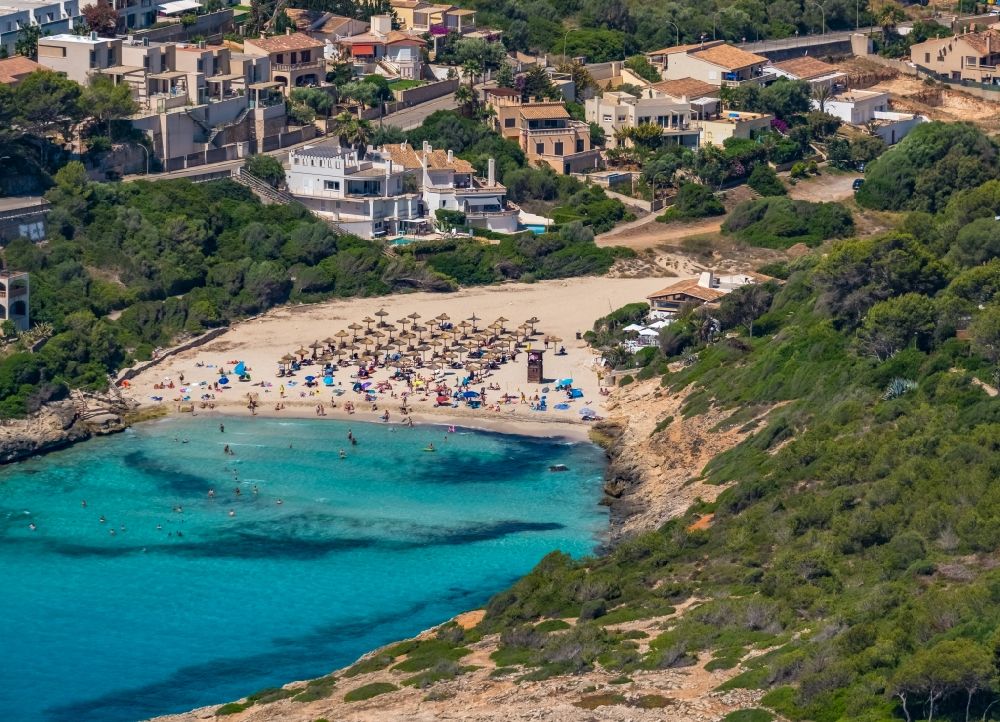 Cala Anguila-Cala Mendia from the bird's eye view: Beach landscape along the with umbrella - rows on CALA Estany d'en Mas in Cala Anguila-Cala Mendia in Balearic island of Mallorca, Spain