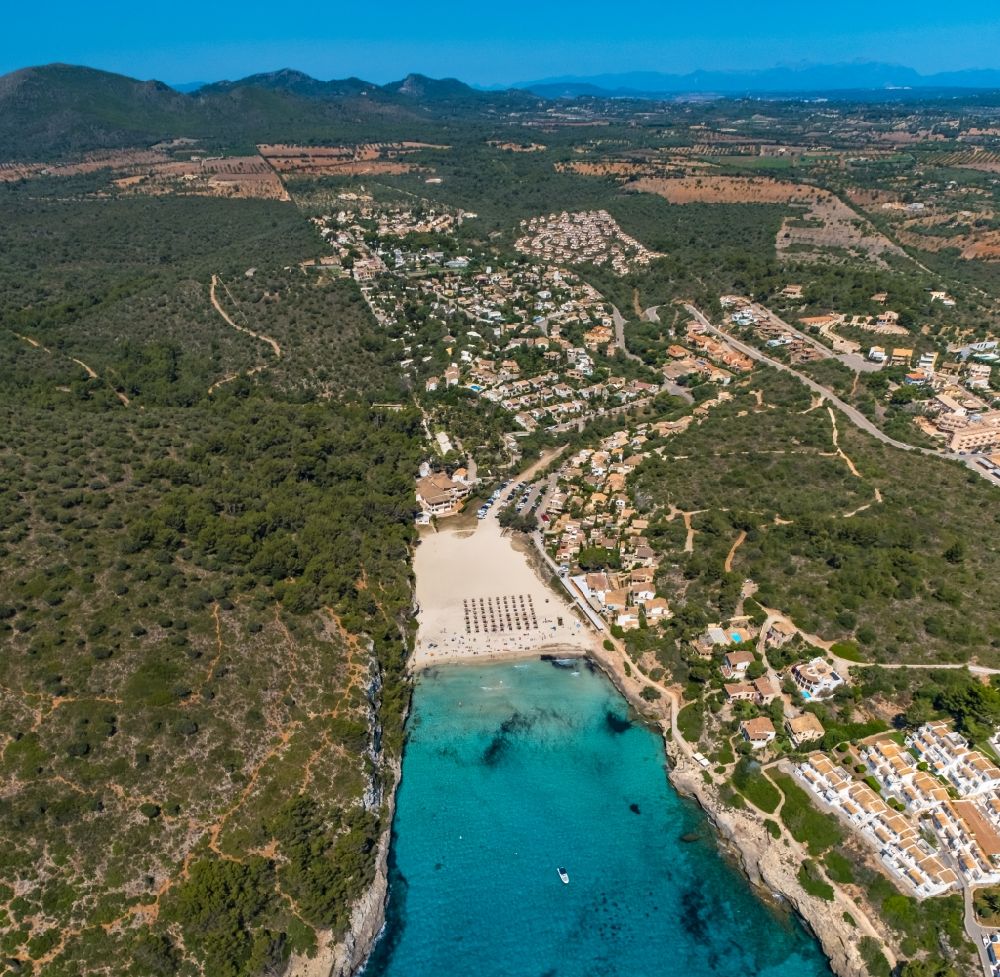 Aerial photograph Manacor - Beach landscape along the with umbrella - rows at the bay of Cala Estany d'en Mas in Cala Anguila-Cala Mendia in Balearic island of Mallorca, Spain