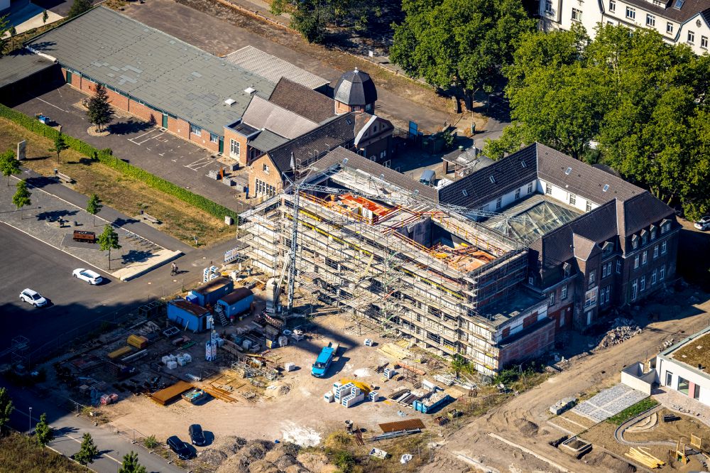 Dinslaken from the bird's eye view: Construction site for reconstruction and modernization and renovation of a building of Kreativ.Quartier Lohberg on street Huenxer Strasse in Dinslaken at Ruhrgebiet in the state North Rhine-Westphalia, Germany
