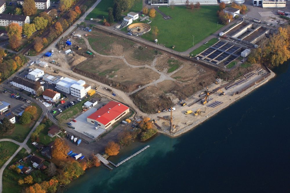 Aerial photograph Grenzach-Wyhlen - Remediation at the site of the former wastewater treatment plant of the pharmaceutical company Roche in Grenzach-Wyhlen in Baden -Wuerttemberg. Construction of a temporary landing stage on the river Rhine for the removal of the excavated material