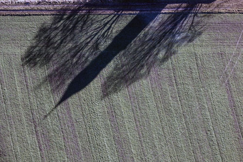 Essenbach from the bird's eye view: Shadow of the christian church St. Wolfgang in Essenbach in Bavaria