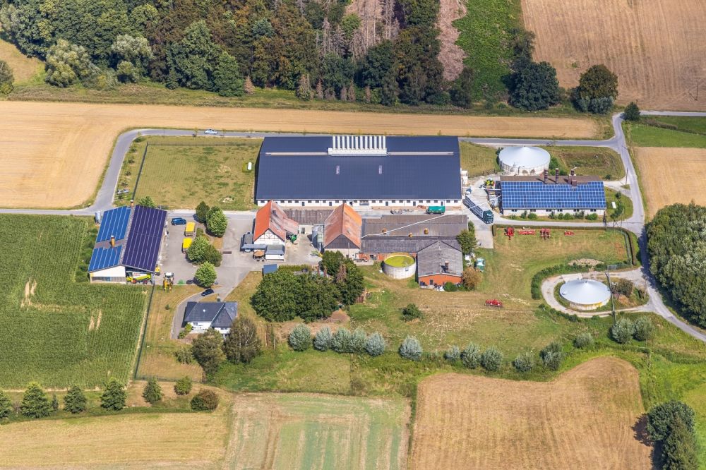 Hohenheide from the bird's eye view: Barn building on the edge of agricultural fields and farmland in Hohenheide in the state North Rhine-Westphalia, Germany