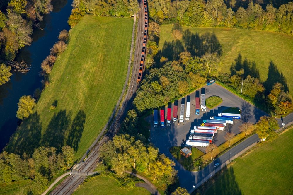 Aerial image Arnsberg - Railway track and overhead wiring harness in the route network of the Deutsche Bahn with a parking area for trucks at Altes Feld in the district Wennigloh in Arnsberg in the state North Rhine-Westphalia, Germany