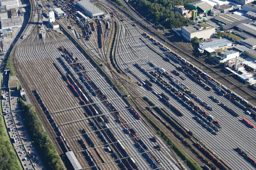 Muttenz from the bird's eye view: Railway tracks and cargo trains in the route network of the Swiss Railway SBB in Muttenz in the canton Basel-Landschaft, Switzerland