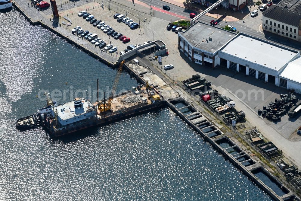 Flensburg from the bird's eye view: Ship - specialized vessel demolishes port facilities at the parking lot Parkplatz Phaenomenta on the Schiffbruecke in the port in Flensburg in the state Schleswig-Holstein, Germany
