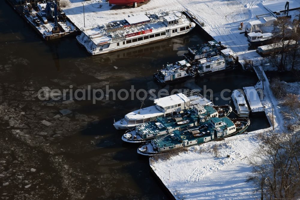 Genthin from above - Ships and boats on wintry and ice-covered Elbe-Havel-Canal in Genthin in the state of Saxony-Anhalt. The snow-covered ships area located at a dock amidst ice floes and cakes