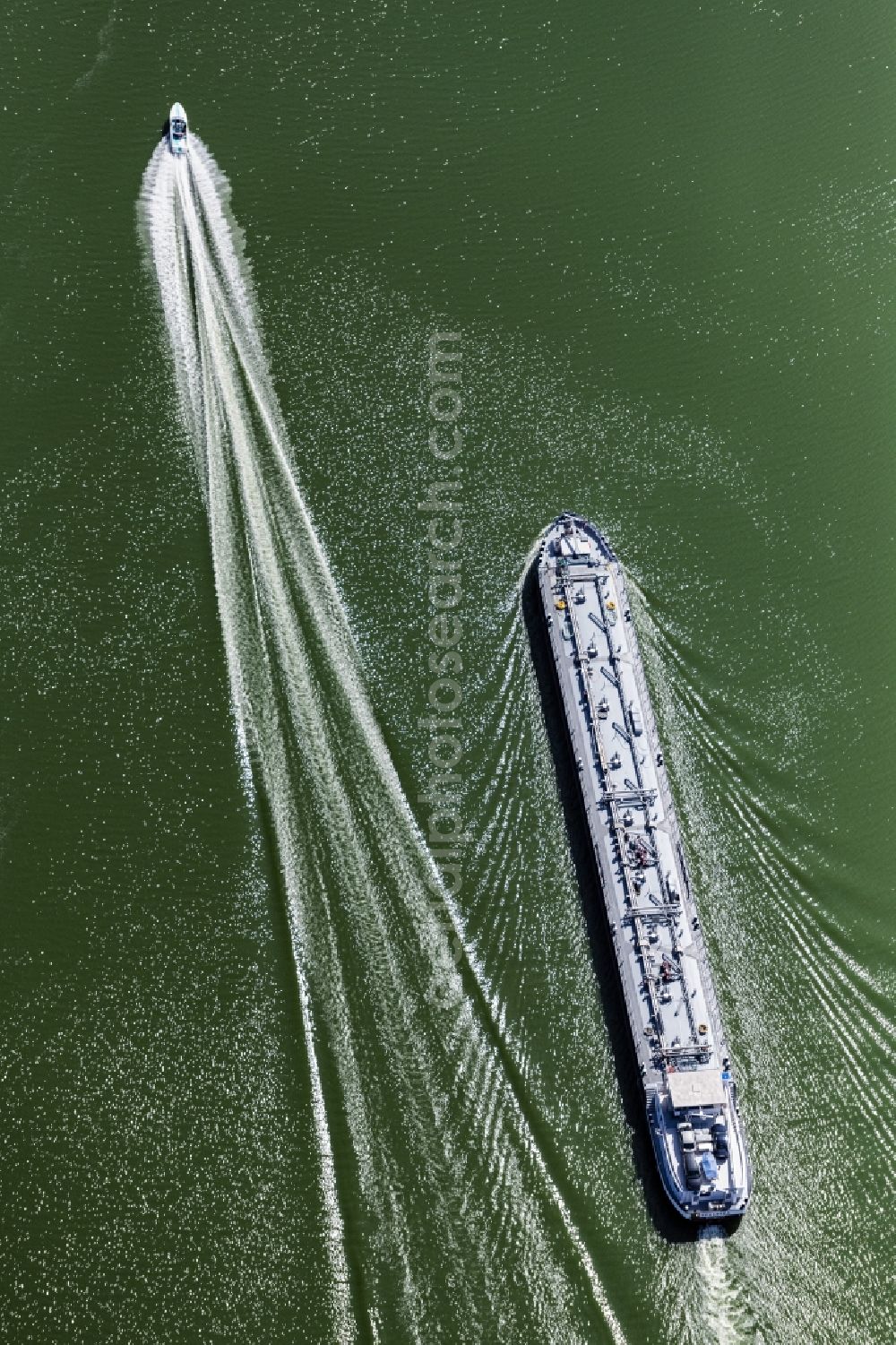 Aerial image Koblenz - Ships and barge trains inland waterway transport in driving on the waterway of the river Mosel, welcher gerade von einem Sportboot ueberholt wird in Koblenz in the state Rhineland-Palatinate, Germany