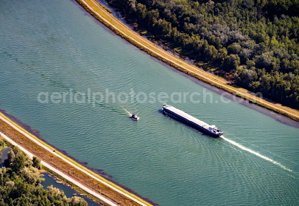 Aerial photograph Daubensand - Ships and barge trains inland waterway transport in driving on the waterway of the river Oberrhein in Daubensand in Grand Est, France