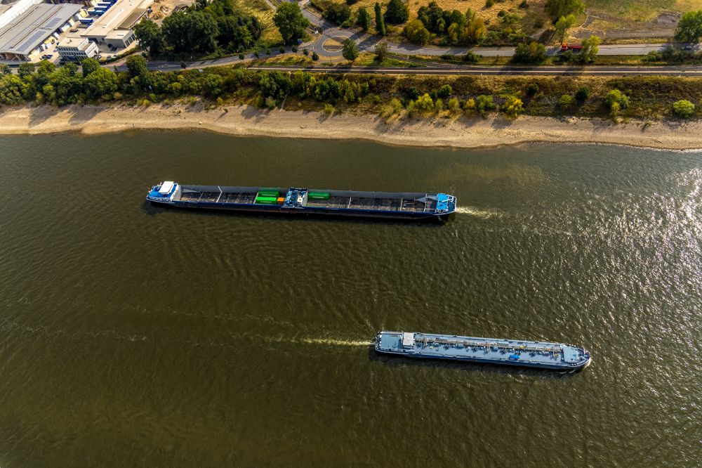 Krefeld from above - Ships and barge trains inland waterway transport in driving on the waterway of the river of the Rhine river in Krefeld in the state North Rhine-Westphalia, Germany