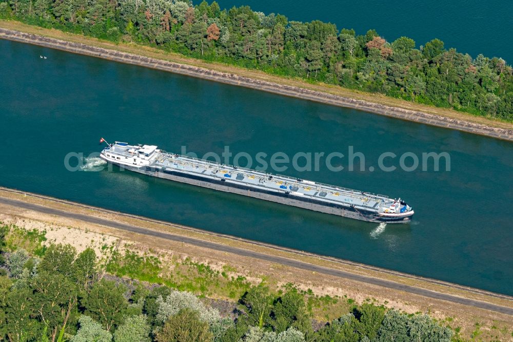 Marckolsheim from the bird's eye view: Ships and barge trains inland waterway transport in driving on the waterway of the river on Rhein in Marckolsheim in Grand Est, France